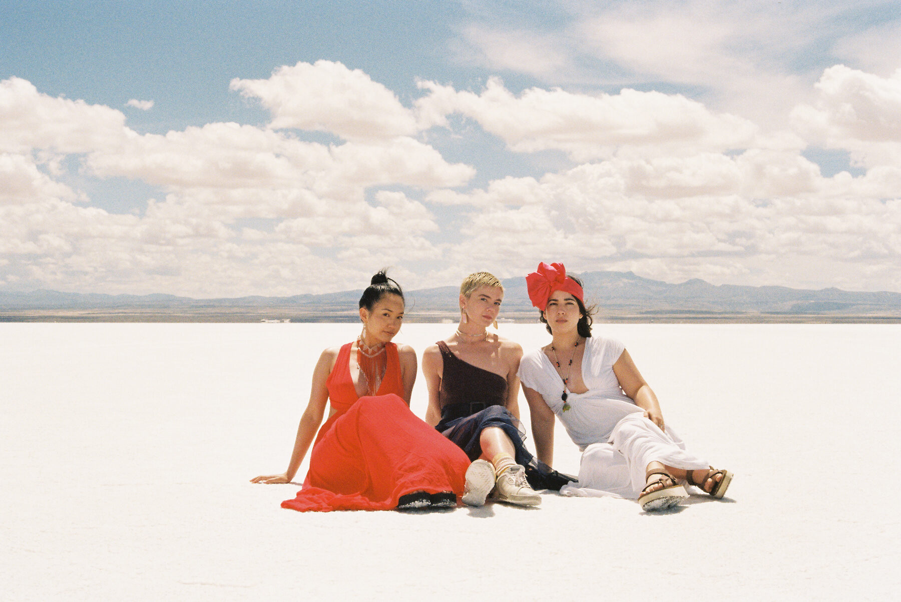 Three guests sitting together, wide open ground behind them